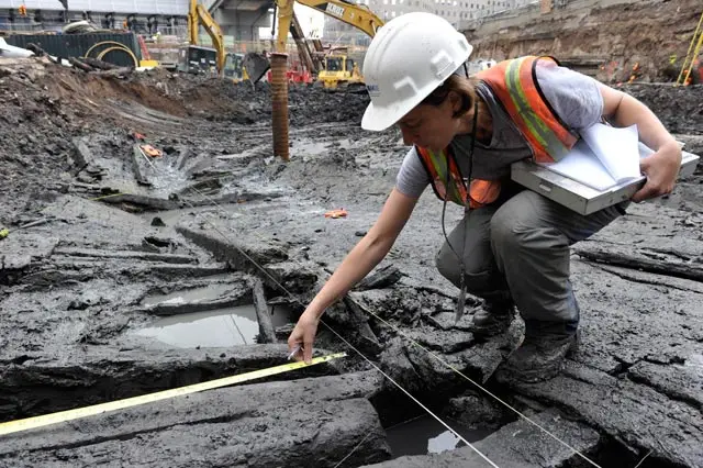 An archaeologist examines the hull found at the World Trade Center site